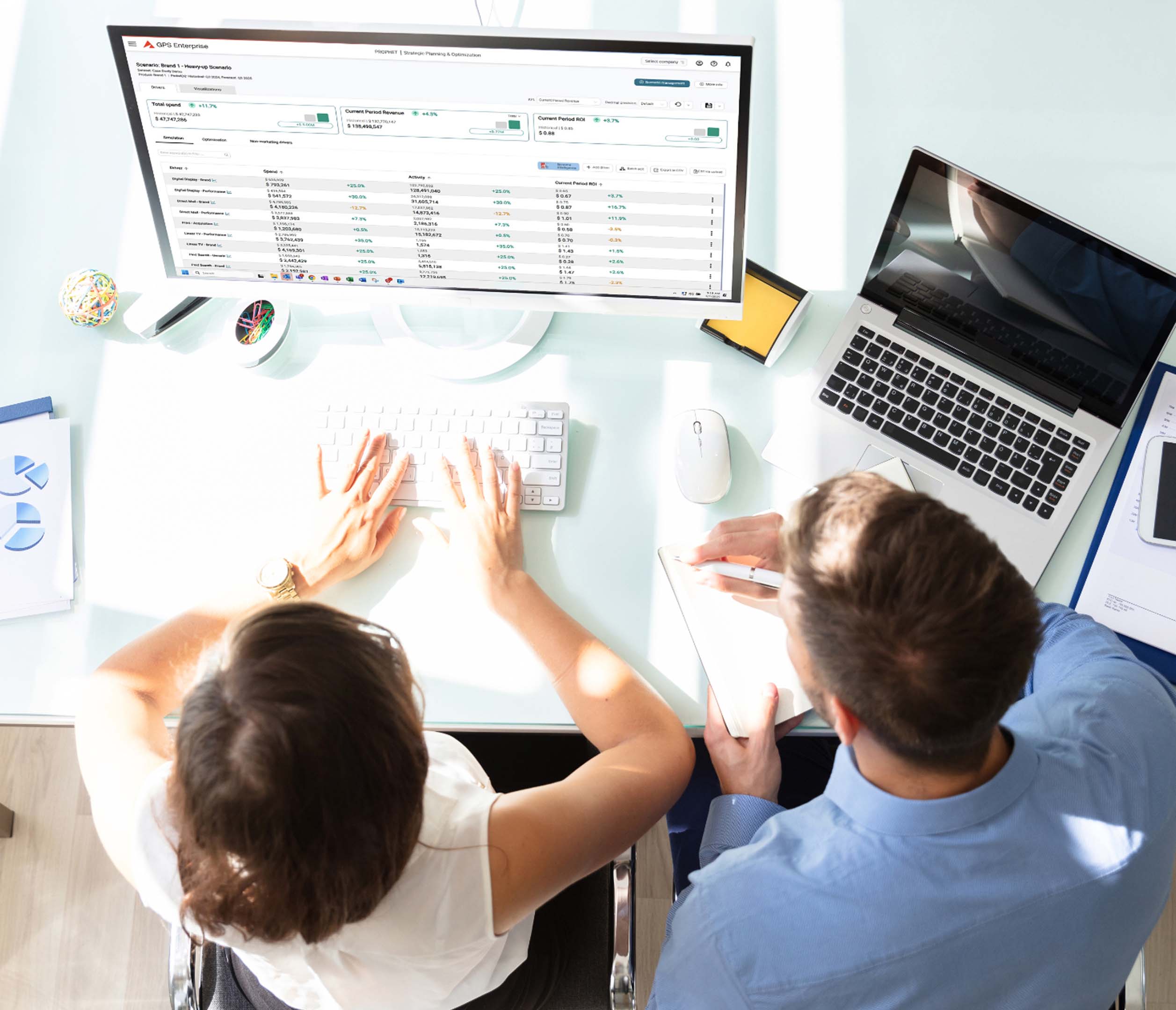 man and woman working on computer top view
